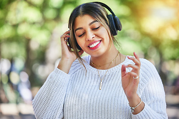 Image showing Outdoor, music and woman with headphones, listening and streaming audio with happiness, stress relief and dance. Female person, radio and happy girl with a headset, smile and online sounds in a park