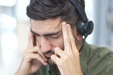 Image showing Man, headache and call center in stress, mistake or client problem in customer service or support at office. Male person, consultant or agent with headphones and bad head pain in burnout at workplace