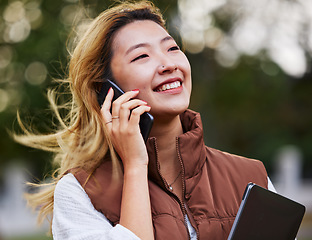 Image showing Happy, talking and a woman on a phone call while thinking in the city for business or networking. Smile, idea and an Asian employee with communication on a mobile for conversation, chat or planning