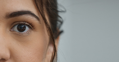 Image showing Woman, eye and zoom in portrait by space, mockup or health for vision, contact lens or biometric test. Girl, model and closeup for cybersecurity banner, retina or cornea scan for safety by background