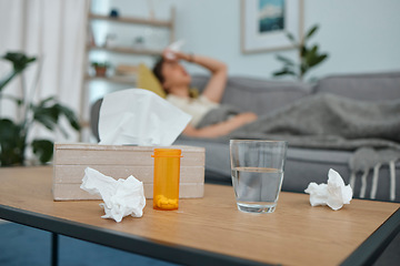 Image showing Pills, tissue and glass on table, living room or sick woman laying on sofa with stress, pain or frustrated. Girl, allergies or medical problem with water, medicine or fatigue on lounge couch in home