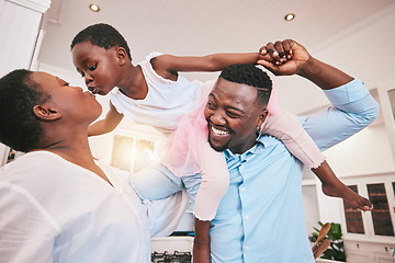 Image showing Family, kiss or piggyback and a girl in the home with her parents for fun or bonding together. Mothers day, love or smile with african parents and their daughter looking playful in their house