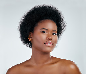 Image showing Portrait, natural hair and black woman with glow in skincare or cosmetic on white background in studio. Beauty, face and dermatology for african girl with shine for treatment or self love in mock up.