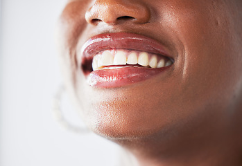 Image showing Happy, lips and beauty with a woman closeup in studio on a gray background for makeup or cosmetics. Smile, mouth and teeth with a confident female person posing to promote dental health or hygiene