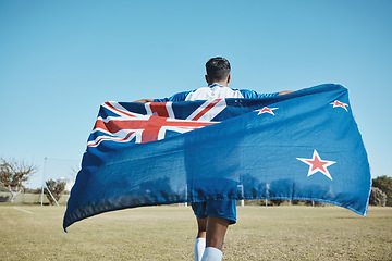 Image showing Flag, sports and a man running on a field with a blue sky to celebrate outdoor. Banner, champion and athlete person with patriotism and pride after winning competition to support New Zealand country