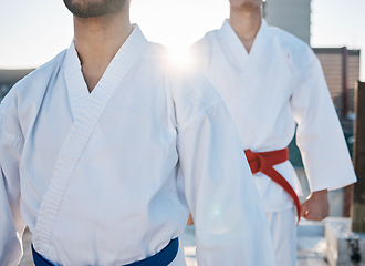 Image showing Karate, gi and men in city for training, workout and start exercise with lens flare. Martial arts, sport and people in competition for taekwondo, battle or fight challenge for healthy body in fitness
