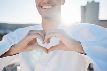 Image showing Heart in hands, karate and man in city for training, exercise and sports in morning outdoors. Happy, love emoji and male person with hand gesture for care in town for combat, martial arts and workout