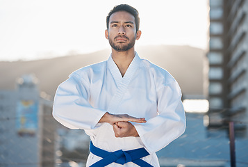 Image showing Karate, exercise and focus with a sports man in the city for self defense training or a combat workout. Fitness, health and fighting with a serious young male athlete or warrior in an urban town