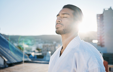 Image showing Karate, wellness and breathing with a sports man in the city for self defense training or a combat workout. Fitness, peace and meditation with a young male fighter or athlete outdoor for mindfulness