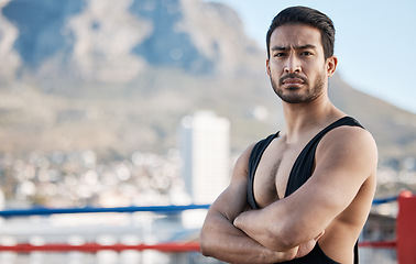 Image showing Man, wrestling and arms crossed in portrait for sport, ring and fitness on rooftop, strong muscle and mindset. Young athlete, serious face and healthy body for fight, mma and training in Cape Town