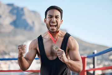 Image showing Champion man, wrestling medal and celebration in portrait, success or fist in air for sports contest on roof in Cape Town. Young athlete, games and winner for goal, achievement and fight competition