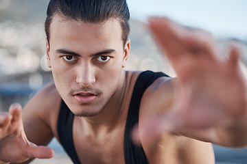 Image showing Hands, portrait and a man doing karate in the city, training for taekwondo or sports competition. Serious, fitness and a professional athlete with a move for a workout or martial arts exercise