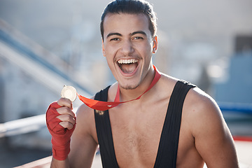 Image showing Winner, wrestler or portrait of happy man with medal to celebrate winning a wrestling competition with pride. Success, fitness or excited athlete with fighting victory award, gold or prize in a ring