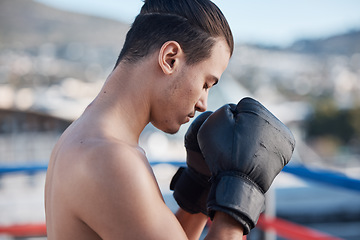 Image showing Sports, boxer praying or man fighting in a ring on rooftop in city for combat training or meditation to God. Eyes closed, athlete or fighter ready for boxing workout, fitness exercise or match battle