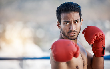 Image showing Fitness, boxing or male boxer in a ring training, exercise and punching with strong power in workout. Athlete, challenge or healthy Asian man fighting on city rooftop outdoors for skills development