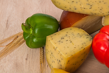 Image showing Bosnian traditional cheese served on a wooden container with peppers, parade and onions isolated on a white background