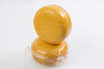 Image showing A piece of homemade vacuumed traditional Bosnian cheese isolated on a white background