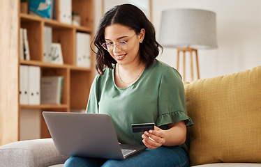 Image showing Online shopping, laptop and credit card, happy woman on sofa in living room for internet banking app in home. Ecommerce payment, smile and cashback, girl with computer browsing retail website sale.