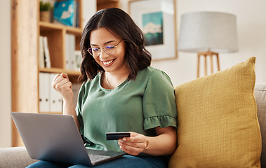 Image showing Winning, laptop and credit card, happy woman on sofa in living room for internet banking in home. Ecommerce payment, smile and cashback, girl at computer browsing retail website for online shopping.