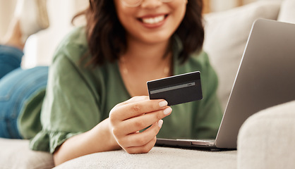 Image showing Relax, online shopping and credit card, woman on sofa in living room for internet banking in home with laptop. Happy ecommerce payment, smile and cashback, girl on couch with computer on website sale