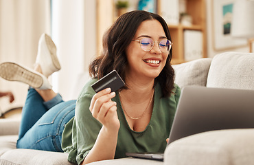 Image showing Online shopping, relax and credit card, woman on sofa in living room for internet banking app in home with laptop. Ecommerce payment, smile and cashback, girl at computer browsing retail website sale