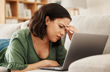 Image showing Woman, home and headache with laptop and remote work stress on a sofa feeling frustrated. House, female person and confused from computer problem with anxiety from online website project on a couch