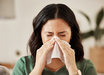 Image showing Blowing nose, tissue and woman in a living room with flu, cold and hay fever, crisis or viral infection in her home. Sneezing, allergies and person with virus or coughing illness in a lounge in house