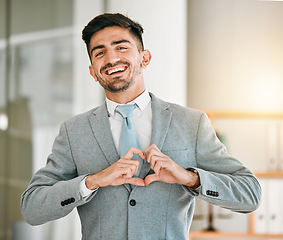 Image showing Portrait of businessman, heart hands and smile in office with confidence, opportunity and happiness at startup. Emoji, business and face of happy man with love hand gesture in professional workplace.