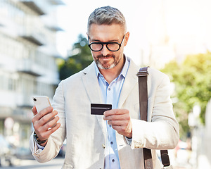 Image showing Phone, credit card and businessman travel using online payment for a commute mobile app, online and on the internet. City, corporate and mature professional walking with smartphone for ecommerce