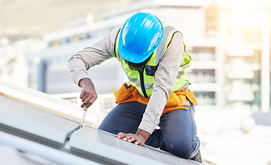 Image showing Man, technician and screwdriver for solar panel installation on rooftop in the city for renewable energy. Male person, engineer or contractor working on roof in sun for installing eco friendly power