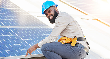 Image showing Black man, portrait and technician in solar panel installation on rooftop in city for renewable energy. Happy African male person, engineer or contractor working on roof in sun for electricity power