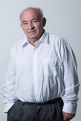 Image showing Senior grey-haired man wearing elegant shirt isolated on white background depressed and worry for distress, crying angry and afraid. Sad expression.