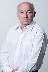 Image showing Senior grey-haired man wearing elegant shirt isolated on white background depressed and worry for distress, crying angry and afraid. Sad expression.