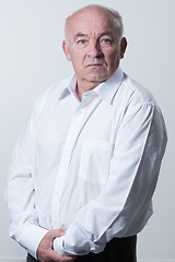 Image showing Senior grey-haired man wearing elegant shirt isolated on white background depressed and worry for distress, crying angry and afraid. Sad expression.