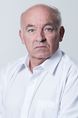Image showing Senior grey-haired man wearing elegant shirt isolated on white background depressed and worry for distress, crying angry and afraid. Sad expression.