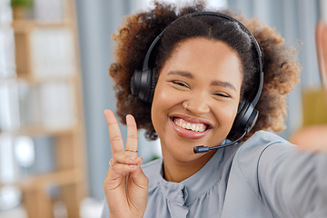 Image showing Callcenter, selfie and happy woman at help desk with peace sign for advice, sales and telemarketing in headset. Consulting, emoji and virtual assistant, customer service agent or hand gesture for crm