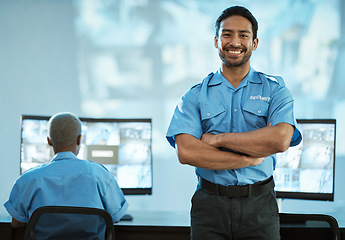 Image showing Portrait, security and man with smile in control room as employee at agency with asian. Face, safety, professional and working at data centre for surveillance for crime on video with technology.