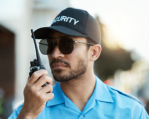 Image showing Security guard, safety officer or man with a walkie talkie outdoor on a city road for communication. Serious face of person with a radio on urban street to report crime, investigation or surveillance