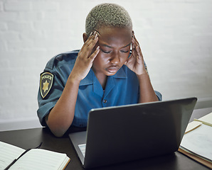 Image showing Police, woman with headache and working with stress on computer or frustrated with case, report or anxiety in security. African, officer and tired from work on documents in office or station