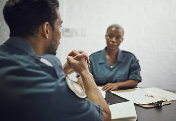 Image showing People, police and team in meeting for crime report, documents or case discussion at the precinct. Man and woman, law enforcement or officers working together on investigation or paperwork at station