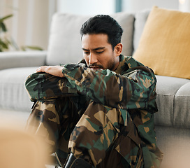 Image showing Sad, trauma and male military soldier sitting on the floor in the living room of his house. Depression, ptsd and man army warrior from Mexico thinking about mental health in the lounge at home.