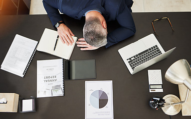 Image showing Business man, top view and sleep on desk, office or report with documents, notebook and laptop. Mature CEO, boss or leader with fatigue, paperwork or computer for audit, accounting and tired by table