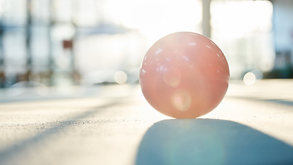 Image showing Gymnastics, sports and ball on floor in gym background for training and exercise on studio ground. Creative performance, fitness and closeup of equipment for competition, workout and dance class