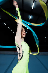 Image showing Ribbon, dance and rhythmic gymnastics, woman in gym with action and performance for fitness. Competition, athlete and female gymnast, dancer with creativity and art, routine and energy at arena