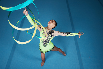 Image showing Dance, rhythmic gymnastics and woman in gym with ribbon in air, action with performance top view and fitness. Competition, athlete and female gymnast, creativity and art, routine and energy at arena