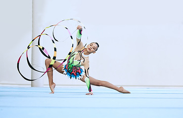 Image showing Gymnastics woman, ribbon and floor in portrait, competition or sport for fitness, performance or studio. Gymnast, athlete girl and professional dancer with balance, exercise or contest for creativity