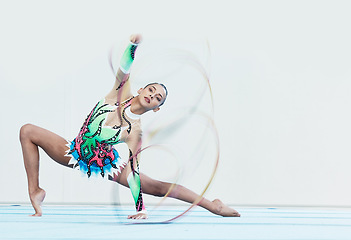 Image showing Gymnastics performance, woman and ribbon in portrait for competition, sport or fitness on studio floor. Gymnast, athlete girl and professional dancer with balance, training or contest with creativity