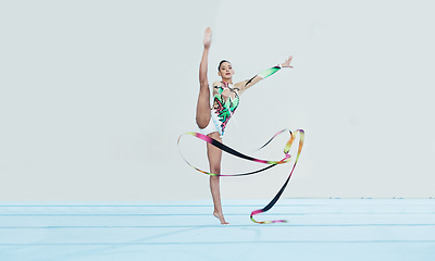 Image showing Gymnastics training, woman and ribbon with legs split for competition, sport and balance in portrait. Gymnast, athlete girl or professional dancer for concert, performance and contest with creativity