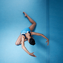 Image showing Woman, gymnastics with fitness and athlete, stretching and workout routine with mockup space and top view. Female gymnast, exercise and flexibility with health and sports in gym, training and body