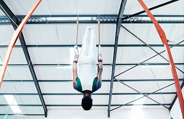 Image showing Gymnastics, rings and man at gym for fitness, workout and body, performance or training. Balance, exercise and guy acrobat at sports studio for athletics, resilience and cardio, hanging or endurance